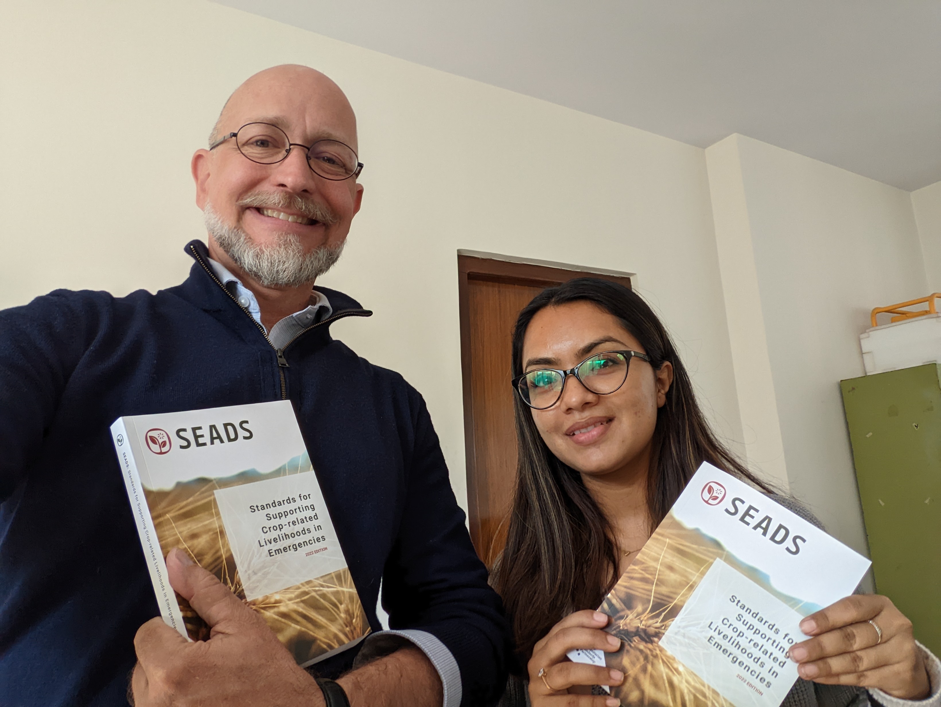 Corey O’Hara and Shradha Bhatta of iDE Nepal receive their new SEADS handbooks